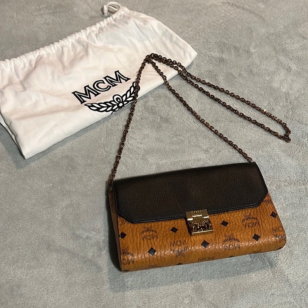 Beautiful MCM Crossbody Clutch. Never used, perfect condition with duster.